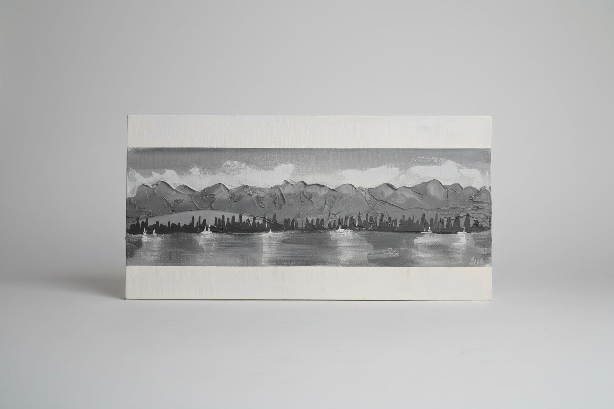 Black and white illustration of a cityscape with mountains and water.